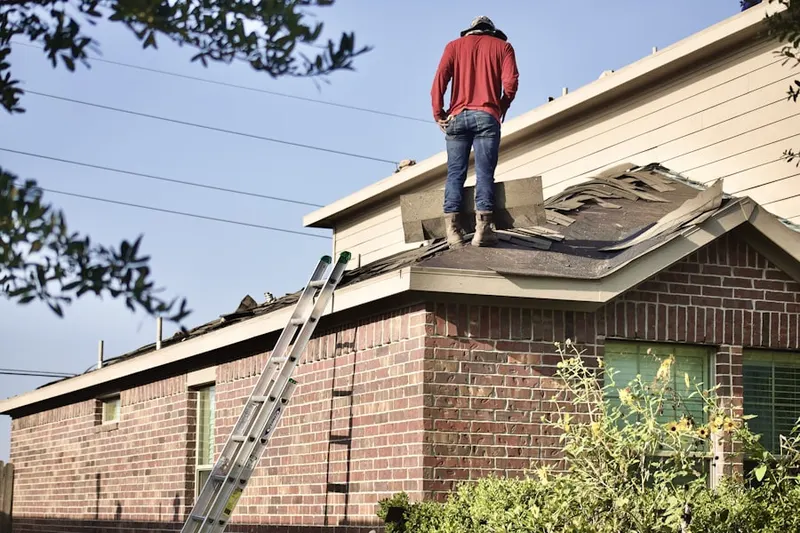 Professional roofer working on a residential roof in Hourglass
